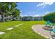 Green backyard with a seating area, a fire pit and a hammock, perfect for relaxation and entertaining guests at 3922 Fontainebleau Dr, Tampa, FL 33634