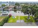Gorgeous waterfront property featuring lush lawn, fire pit, mature tree, and private dock for idyllic outdoor living at 3922 Fontainebleau Dr, Tampa, FL 33634