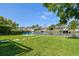 Wide open backyard with canal and dock views, blue chairs and grassy areas perfect for outdoor entertaining at 3922 Fontainebleau Dr, Tampa, FL 33634
