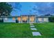 Wide shot of the backyard featuring the patio, lawn and beautiful landscaping at 3922 Fontainebleau Dr, Tampa, FL 33634