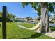 Shady backyard with a hammock strung from a large tree, and view of the canal and dock at 3922 Fontainebleau Dr, Tampa, FL 33634