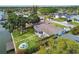 A verdant backyard with a fire pit, waterfront access, mature trees, and a waterfront dock at 3922 Fontainebleau Dr, Tampa, FL 33634