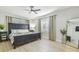 Well-lit bedroom with dark wood furnishings, neutral decor, and large windows at 3922 Fontainebleau Dr, Tampa, FL 33634