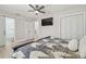 Modern bedroom with a view to the bathroom, a ceiling fan, and double closets at 3922 Fontainebleau Dr, Tampa, FL 33634