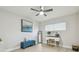 Bright bedroom featuring light wood floors, ceiling fan, and built-in vanity area for a stylish retreat at 3922 Fontainebleau Dr, Tampa, FL 33634