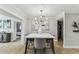 Dining room with modern lighting fixture and artwork, adjacent to other rooms in the home at 3922 Fontainebleau Dr, Tampa, FL 33634