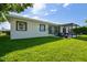 Backyard with covered patio and well-maintained lawn at 3922 Fontainebleau Dr, Tampa, FL 33634