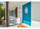Close-up of a bright blue front door with decorative window and modern brick facade at 3922 Fontainebleau Dr, Tampa, FL 33634