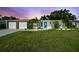 Charming single-story home featuring a well-manicured lawn, inviting blue door, and an attached two-car garage at 3922 Fontainebleau Dr, Tampa, FL 33634