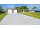 Inviting single-story home featuring a double garage, manicured lawn, and beautiful landscaping for a welcoming curb appeal at 3922 Fontainebleau Dr, Tampa, FL 33634