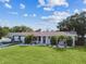 Charming home with a well-maintained front yard, featuring lush green grass and a boat on the driveway at 3922 Fontainebleau Dr, Tampa, FL 33634
