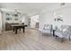 Bright game room featuring light hardwood floors, pool table, and decorative chairs at 3922 Fontainebleau Dr, Tampa, FL 33634