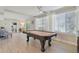 Spacious game room with a vintage pool table and large windows providing ample natural light at 3922 Fontainebleau Dr, Tampa, FL 33634