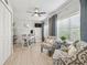 Bright home office with a desk, ceiling fan, and comfortable chairs near window overlooking the landscaped outdoors at 3922 Fontainebleau Dr, Tampa, FL 33634