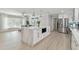 Bright, open kitchen featuring white cabinets, stainless steel appliances, and a large marble island at 3922 Fontainebleau Dr, Tampa, FL 33634