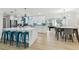 Bright kitchen with an island and teal chairs, open to the dining area and a game room beyond at 3922 Fontainebleau Dr, Tampa, FL 33634