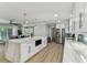 Open kitchen featuring white cabinets, stainless steel appliances, marble island and open access to living room at 3922 Fontainebleau Dr, Tampa, FL 33634