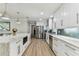 Contemporary kitchen boasts white cabinetry, stainless steel appliances, marble counters, and a geometric tile backsplash at 3922 Fontainebleau Dr, Tampa, FL 33634