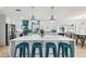 Beautiful kitchen with white cabinets, modern appliances, stylish backsplash, island seating, and open concept design at 3922 Fontainebleau Dr, Tampa, FL 33634