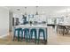 Spacious kitchen with a large island, white cabinets, stainless steel appliances, and modern pendant lighting at 3922 Fontainebleau Dr, Tampa, FL 33634
