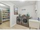 Laundry room featuring a washer, dryer, wash basin and an open pantry to the left of the room at 3922 Fontainebleau Dr, Tampa, FL 33634
