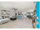 Open-concept living space featuring modern furnishings and a view of the updated kitchen at 3922 Fontainebleau Dr, Tampa, FL 33634