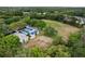 Aerial view of community park featuring basketball courts, a soccer field, and lush greenery at 4063 Ligustrum Dr, Palm Harbor, FL 34685