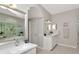 Bathroom with double sinks, soaking tub with a large window at 4063 Ligustrum Dr, Palm Harbor, FL 34685