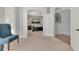 View of the main bedroom with an arched entrance, a chair and an open door at 4063 Ligustrum Dr, Palm Harbor, FL 34685