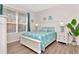 Bright bedroom featuring modern coastal decor, a bright window and stylish furnishings at 4063 Ligustrum Dr, Palm Harbor, FL 34685