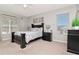 A spacious main bedroom with a dark wood bed frame and plenty of natural light at 4063 Ligustrum Dr, Palm Harbor, FL 34685