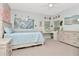 Bright bedroom featuring a queen bed, dresser, desk and plush decorations at 4063 Ligustrum Dr, Palm Harbor, FL 34685