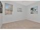 Neutral bedroom features carpet floors, window with blinds and art on the walls at 4063 Ligustrum Dr, Palm Harbor, FL 34685