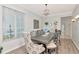 Elegant dining room with wood floors, chandelier, and a window overlooking the front yard at 4063 Ligustrum Dr, Palm Harbor, FL 34685