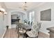 Charming dining area with chandelier, arched entrance and view of a living space at 4063 Ligustrum Dr, Palm Harbor, FL 34685