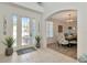 Inviting foyer featuring natural light, tile flooring, and an archway leading to the dining area at 4063 Ligustrum Dr, Palm Harbor, FL 34685