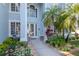 Close up of the front door with a beautiful garden and walkway at 4063 Ligustrum Dr, Palm Harbor, FL 34685