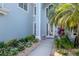 Close up of the front door with a beautiful garden and walkway at 4063 Ligustrum Dr, Palm Harbor, FL 34685