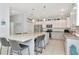 Spacious white kitchen with large island, granite countertops, stainless steel appliances, and tile flooring at 4063 Ligustrum Dr, Palm Harbor, FL 34685