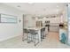 Spacious white kitchen with large island, granite countertops, stainless steel appliances, and tile flooring at 4063 Ligustrum Dr, Palm Harbor, FL 34685