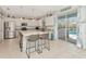 Bright, eat-in kitchen featuring granite counters, stainless appliances, and sliding doors to the outdoor pool at 4063 Ligustrum Dr, Palm Harbor, FL 34685