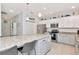 Bright kitchen featuring granite counters, stainless appliances, and white cabinets, and large center island at 4063 Ligustrum Dr, Palm Harbor, FL 34685