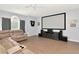 Large living room with hardwood floors, big-screen television, and a comfortable reclining sofa at 4063 Ligustrum Dr, Palm Harbor, FL 34685