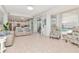 Bright living room with tile flooring, neutral paint, comfortable furniture, and views of the pool area at 4063 Ligustrum Dr, Palm Harbor, FL 34685