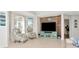 Cozy living room with wood accent wall, modern furniture, and bright windows at 4063 Ligustrum Dr, Palm Harbor, FL 34685