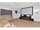 Large living room with hardwood floors, big-screen television, and a comfortable reclining sofa at 4063 Ligustrum Dr, Palm Harbor, FL 34685