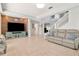 Open-concept living room featuring tile floors, a staircase, and a decorative media center at 4063 Ligustrum Dr, Palm Harbor, FL 34685