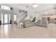 Bright living room showcasing an open floor plan with tile floors, staircase, and comfortable seating at 4063 Ligustrum Dr, Palm Harbor, FL 34685
