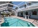 Screened-in pool area with a covered patio, perfect for outdoor entertaining at 4063 Ligustrum Dr, Palm Harbor, FL 34685