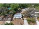 Aerial view of white home with a metal roof and surrounded by mature trees at 4112 Alafia Blvd, Brandon, FL 33511